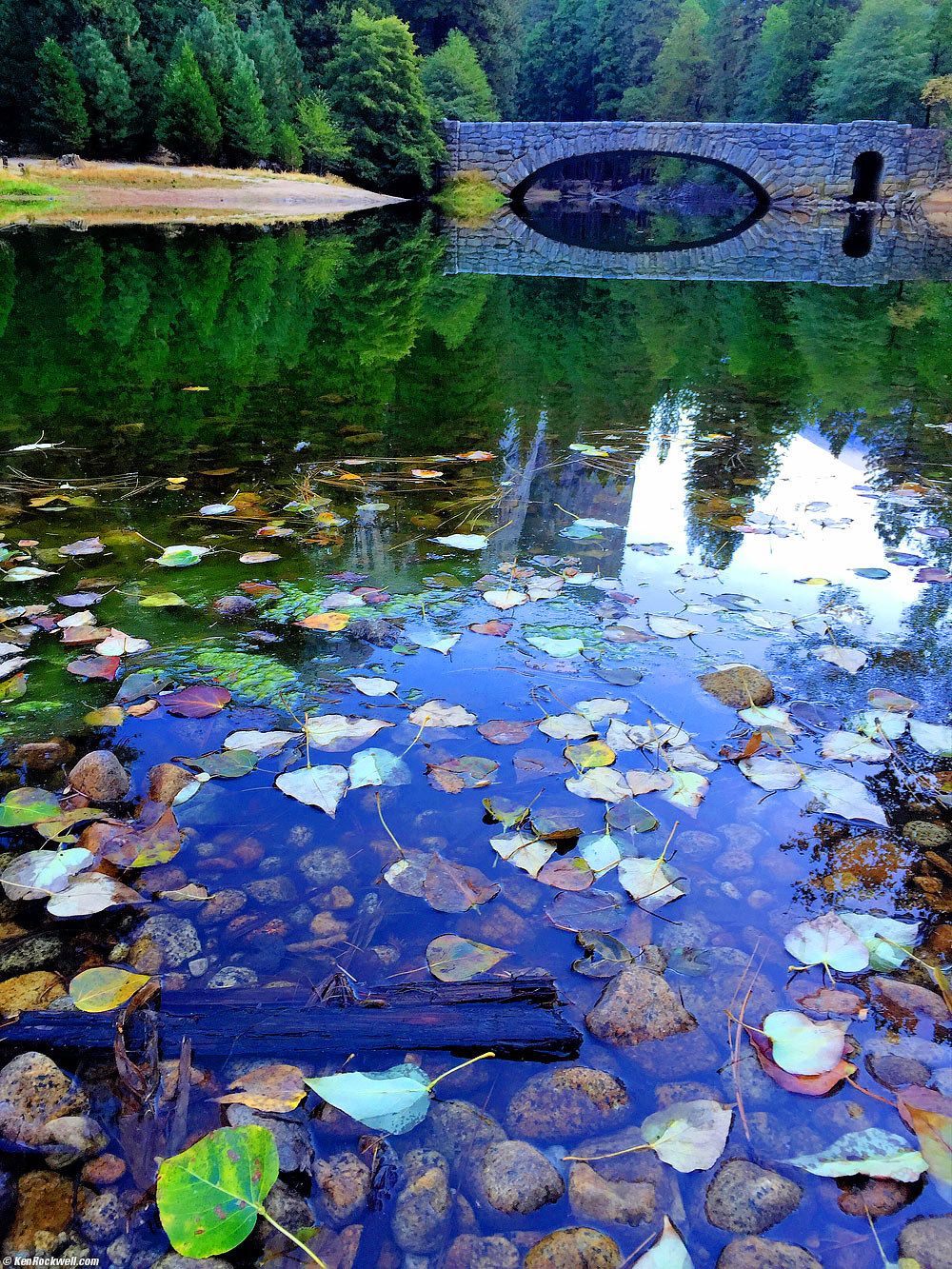 Stoneman Bridge with leaf in water in foreground, Merced River, Yosemite Valley
