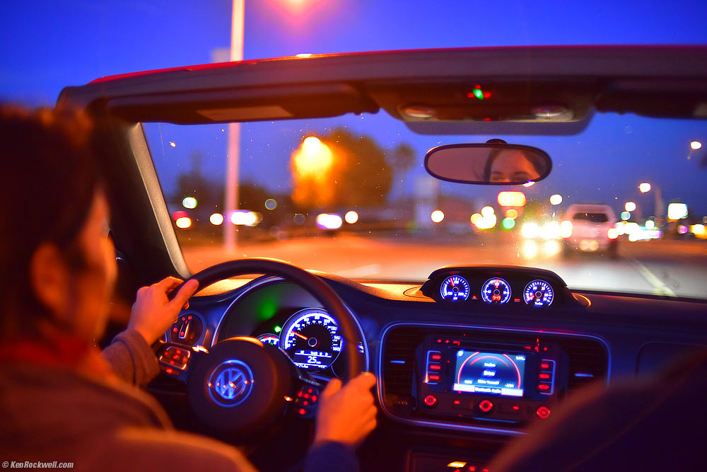 Riding in VW Beetle Convertible along Colorful City Street in Twilight