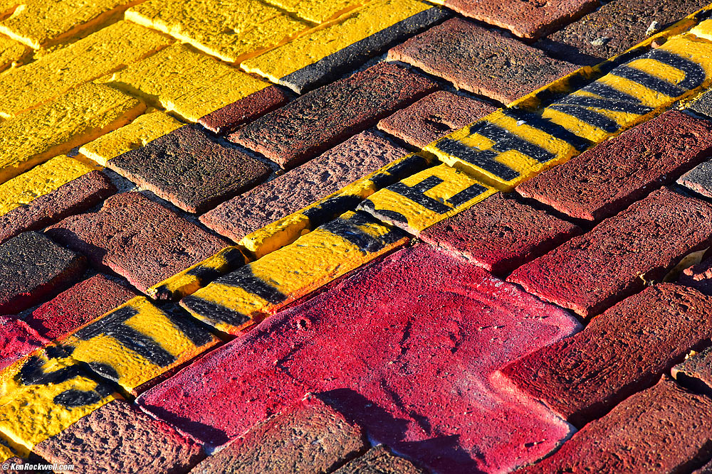 "Stay Back" Painted on Yellow Band on Bricks at Barstow Station