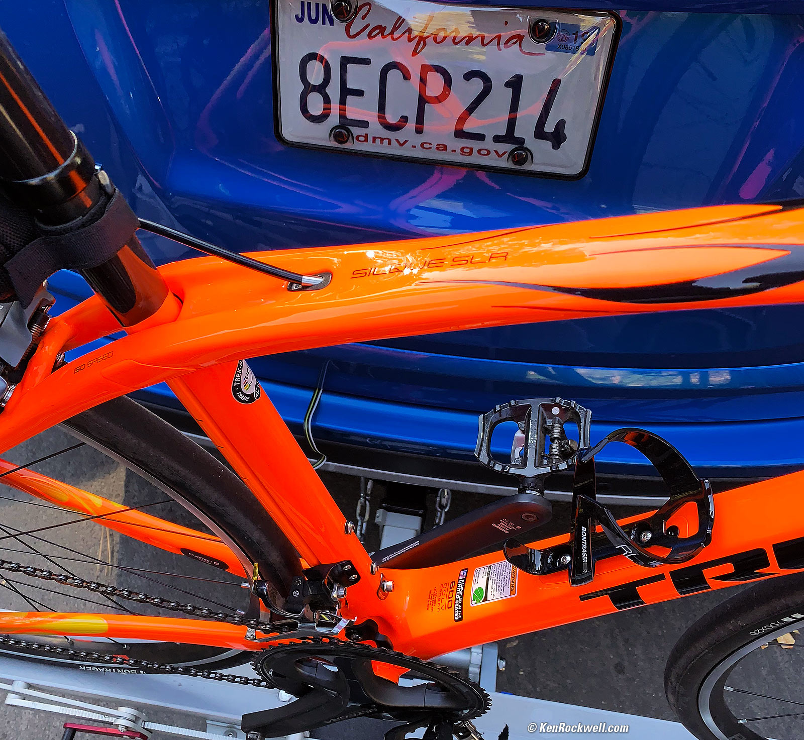 Orange Trek Silque SLR (Made-in-USA) Against Blue Car